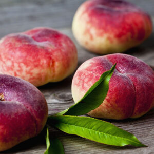 Flat Peaches On Wood
