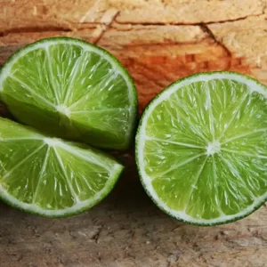 Limes On Wooden Background