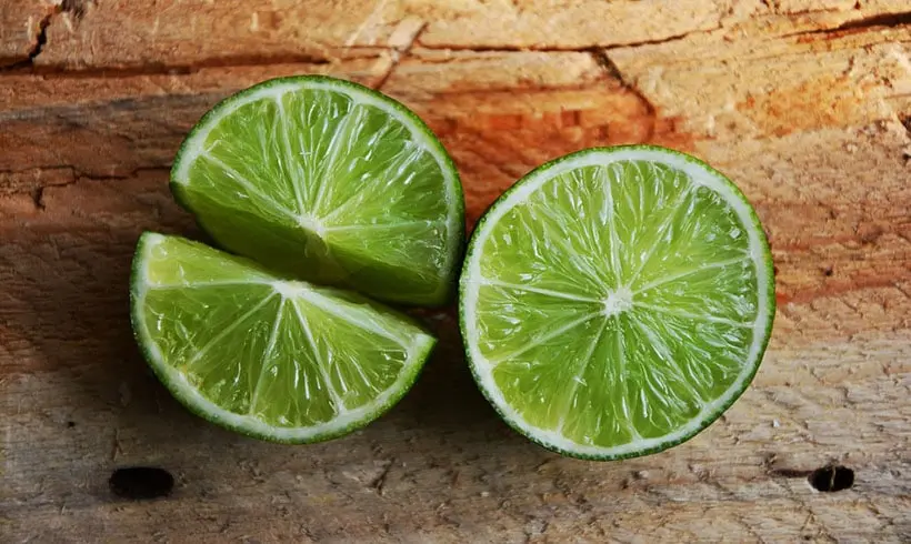 Limes On Wooden Background